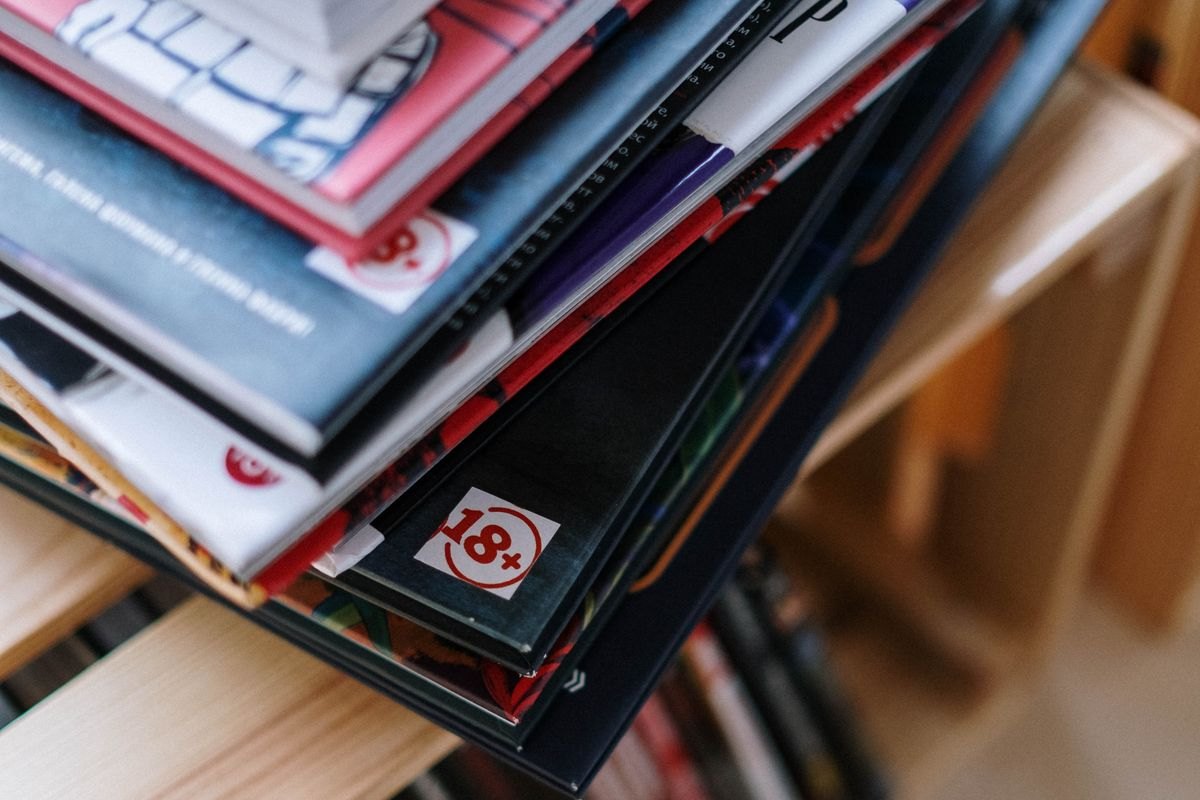 A stacked pile of comics and albums