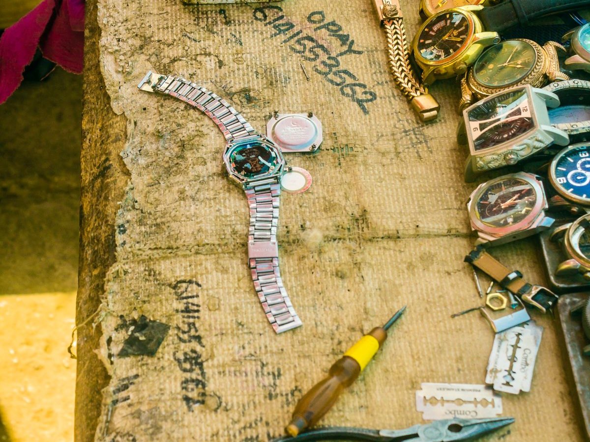 A table covered with old watches and tools