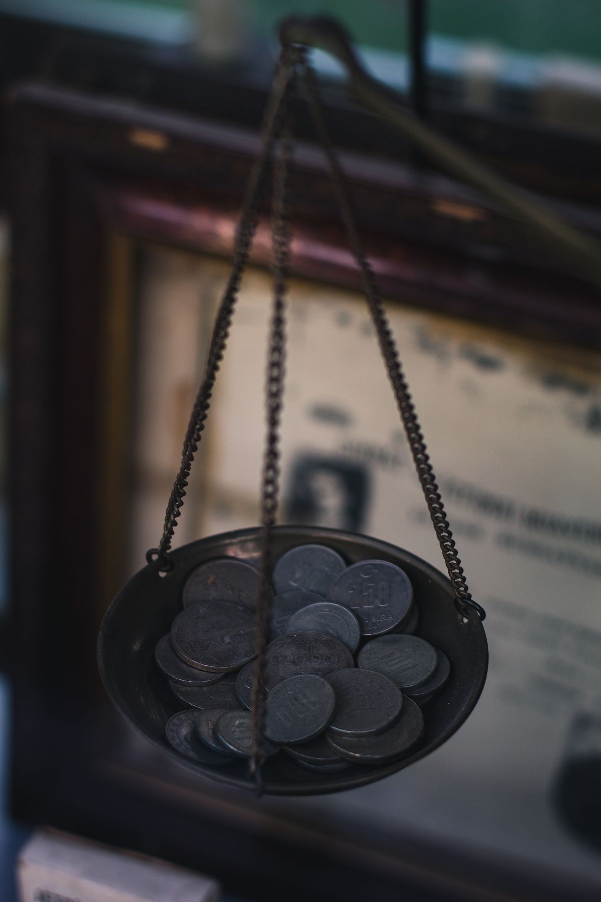 A scale pan filled with coins