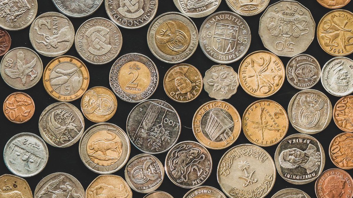 Many different coins on a dark background