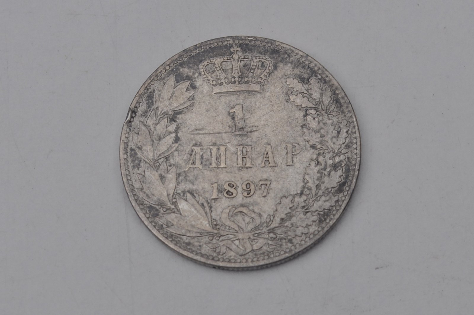 An 1897 silver dinar of the Kingdom of Serbia showing heavy circulation wear