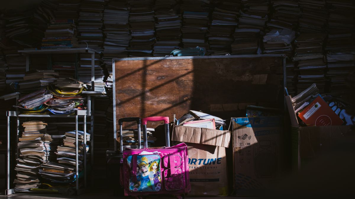 Boxes of old belongings in a dim room