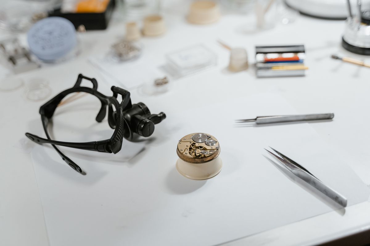 Watchmaker bench with loupe and movement
