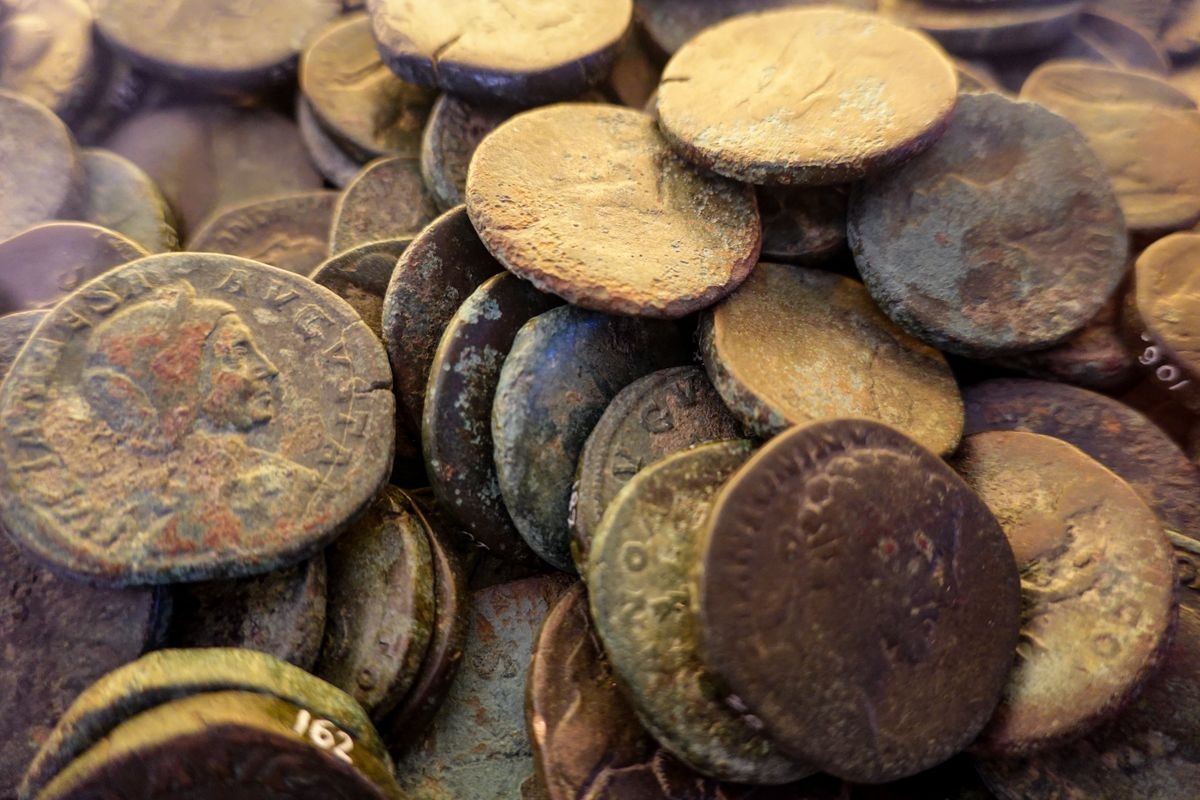 A heap of old coins with heavy patina