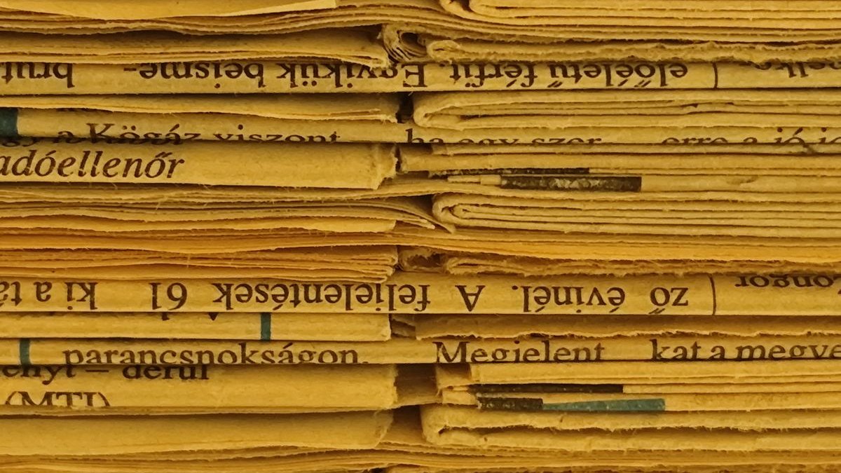 A stack of yellowed newsprint in close-up